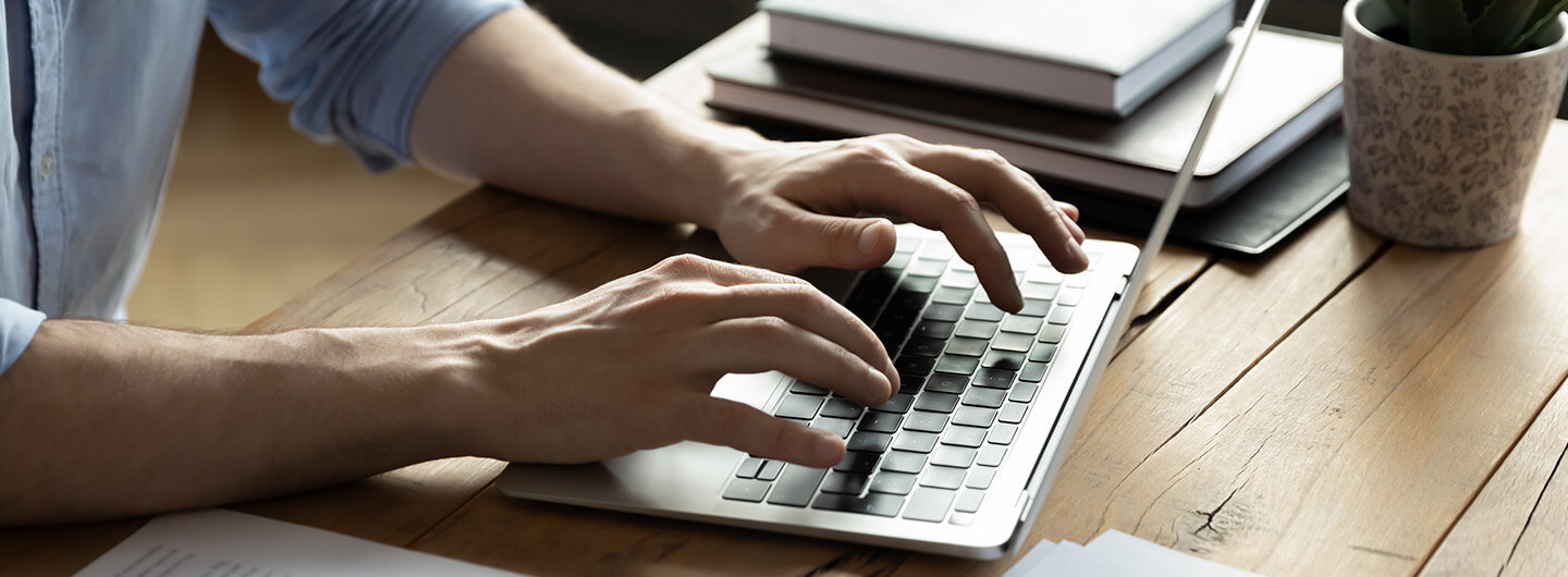 A person typing on a laptop